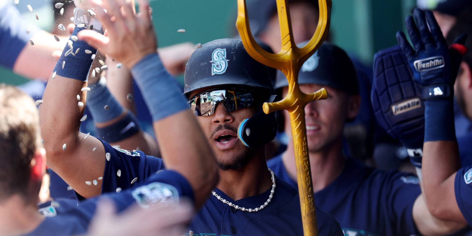 KANSAS CITY, MISSOURI - AUGUST 17:  Julio Rodriguez #44 of the Seattle Mariners is congratulated by teammates in the dugout after hitting a 3-run home run during the 8th inning of the game against the Kansas City Royals at Kauffman Stadium on August 17, 2023 in Kansas City, Missouri. (Photo by Jamie Squire/Getty Images)